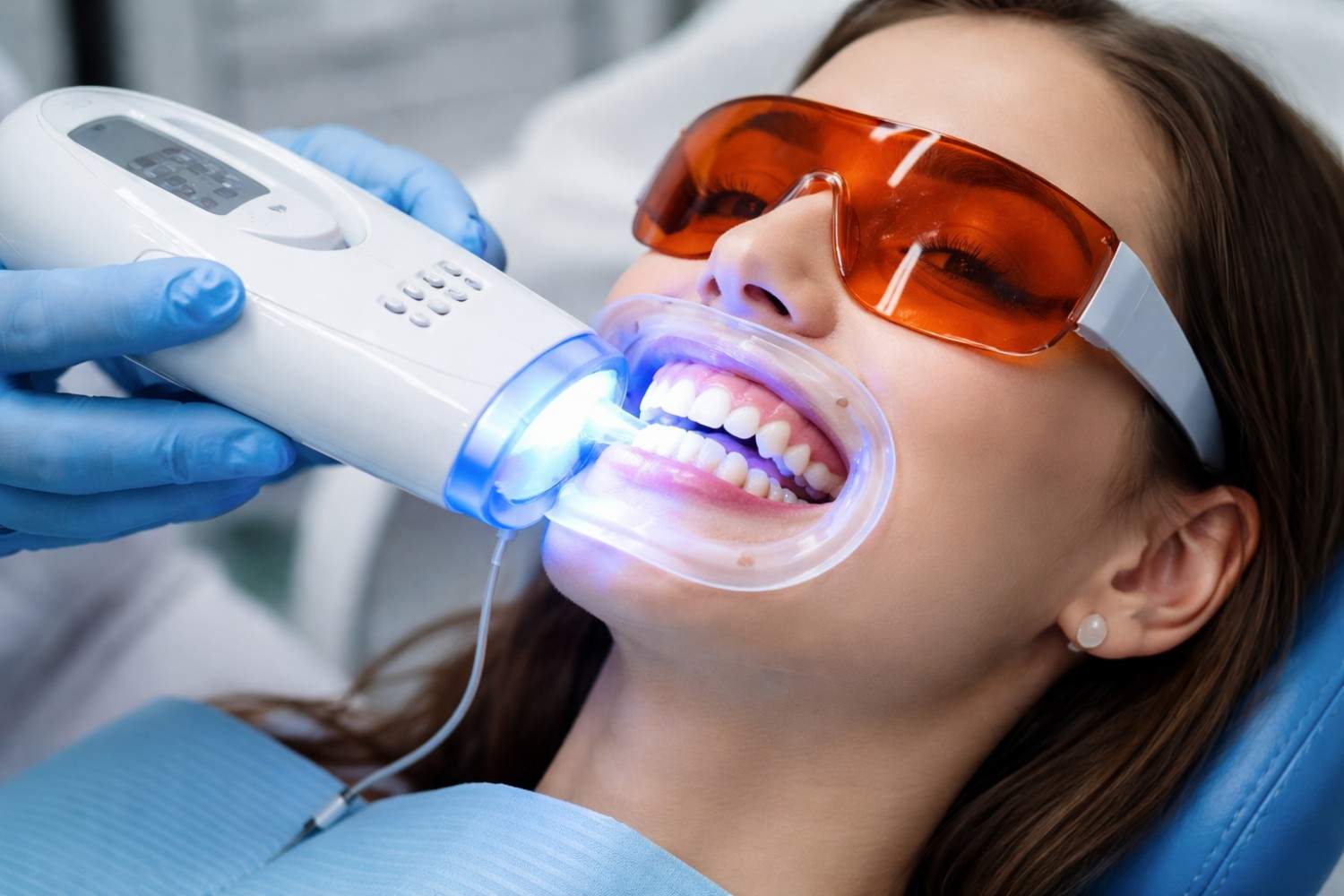 ZOOM teeth whitening treatment using professional dental light activation system